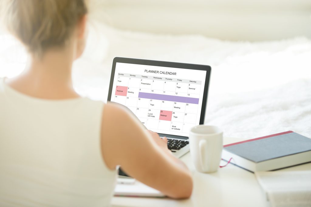 Female planner calender on laptop CRM, diary planning bespoke system