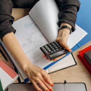 pexels-mikhail-nilov-8296981 woman sat with calculator and laptop