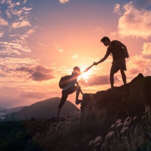 People,Helping,Each,Other,Hike,Up,A,Mountain,At,Sunrise. DCS here to help