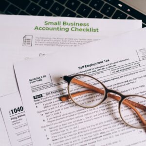 image of accountancy pages with accountancy checklist and a pair of glasses rested on top.