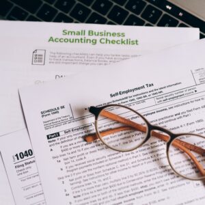 pexels-leeloo-thefirst-8962452 image of accountancy pages with accountancy checklist and a pair of glasses rested on top.