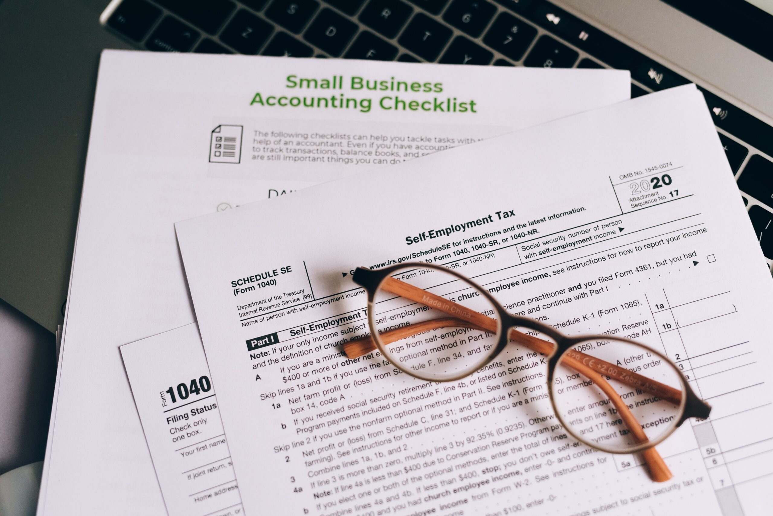 image of accountancy pages with accountancy checklist and a pair of glasses rested on top.